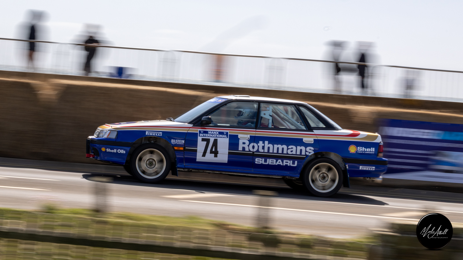 Rothmans Subaru Legacy number 74 in a panning shot on the seafront
