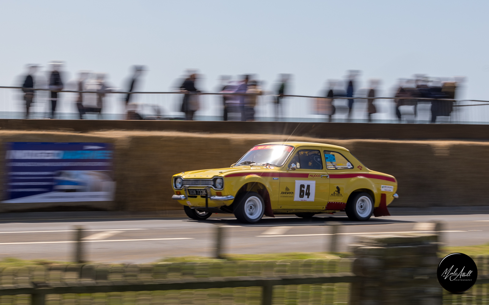 Yellow Ford Escort Mexico number 64 blasting along Culver Parade