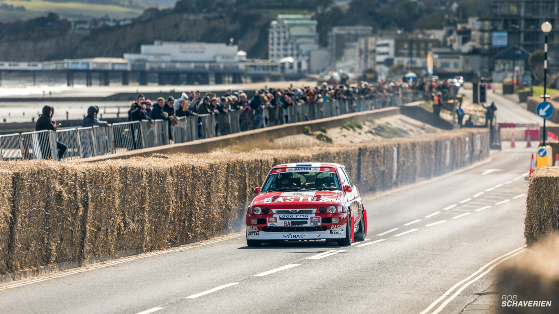 Red and white Ford Escort Cosworth at speed on the closed-road sprint course