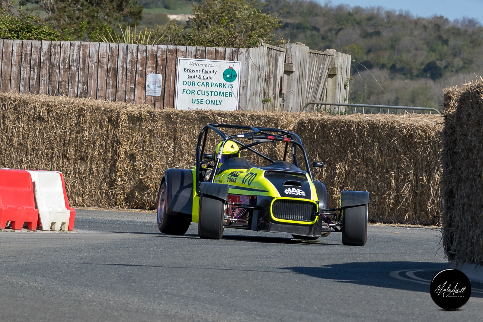 Mac Tools liveried yellow and black sports racer through the bale chicane